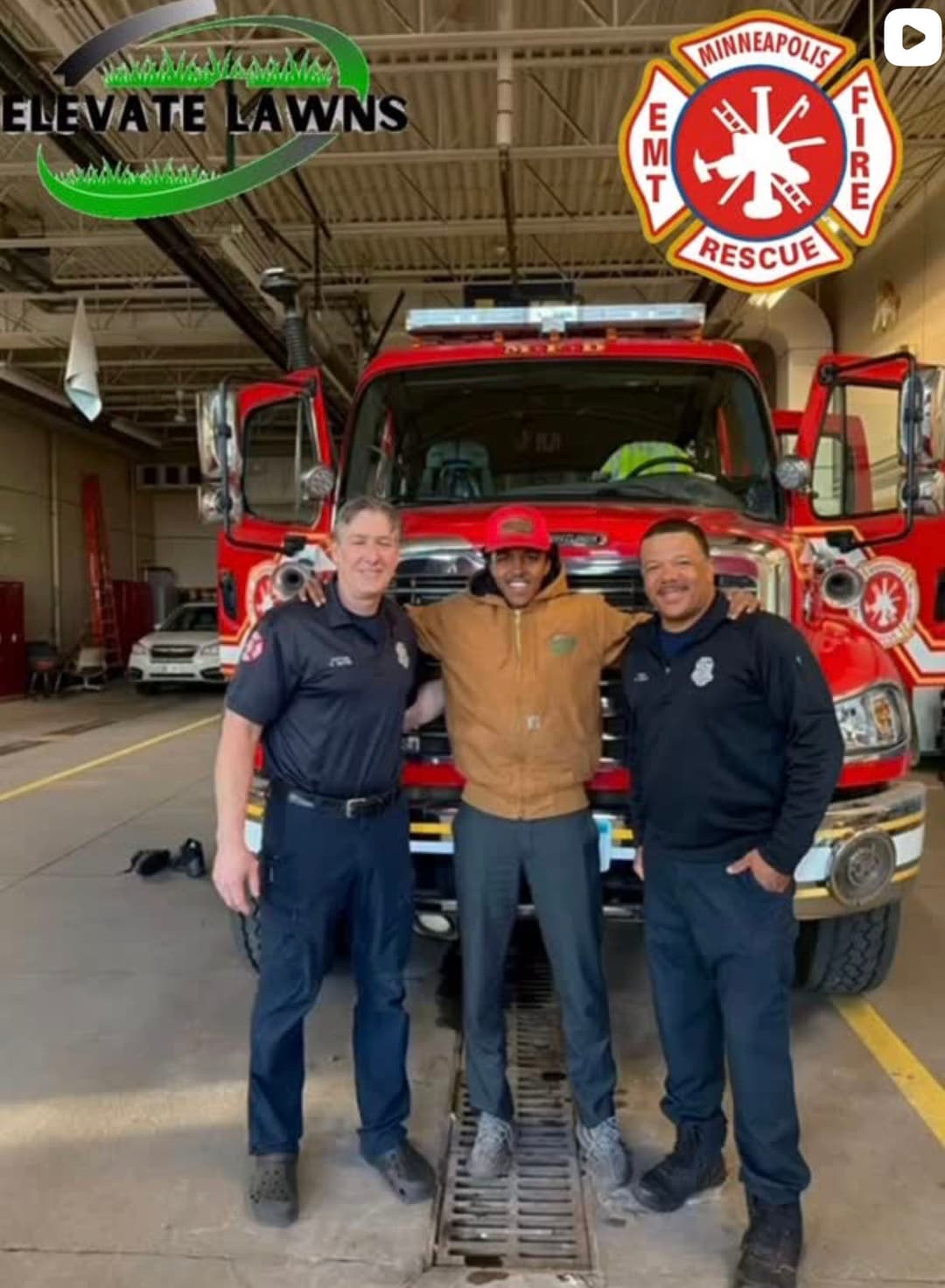 Three firefighters smiling in front of a Minneapolis fire truck at Elevate Lawns.