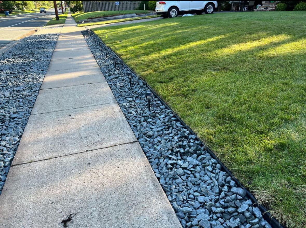 Trap Rock Edging and Diamond Border Along a Front Walkway image