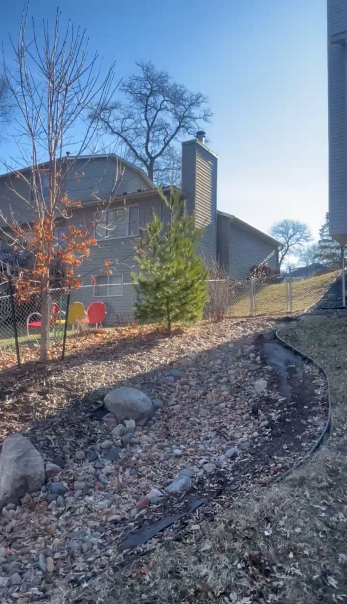 Gallery photos for Fresh Mulch, River Rocks, and Young Trees Planted in One Backyard: Image #1