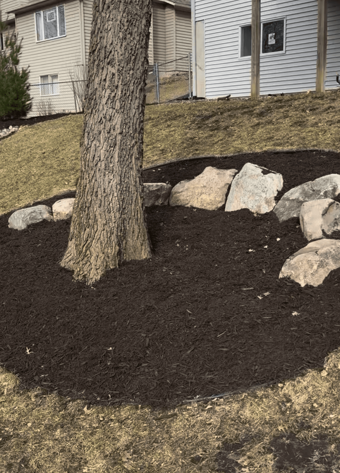 Fresh Mulch and Boulder Edging That Actually Makes a Yard Pop image